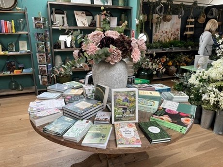 Books displayed on a round table in a garden centre