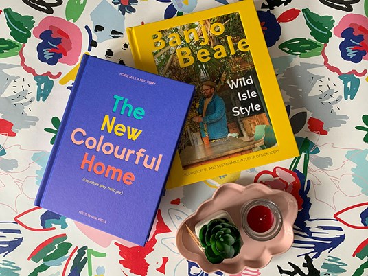 Colourful interiors books on a floral background