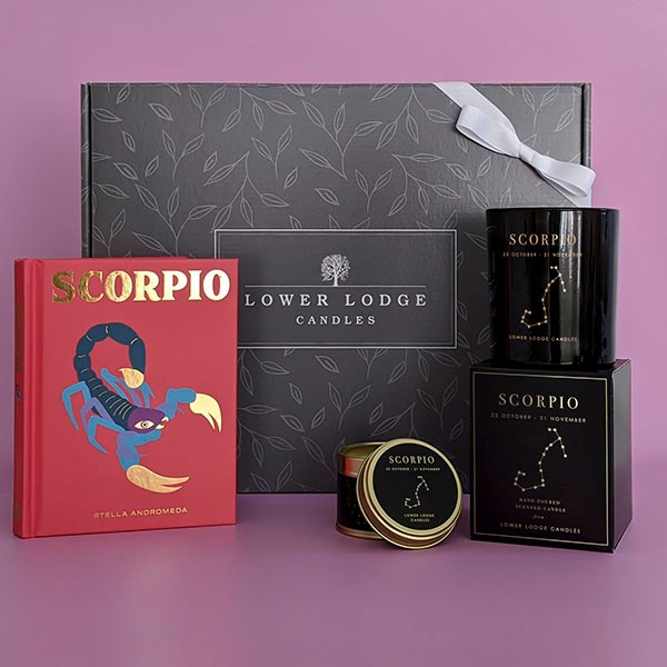 Book called Scorpio standinf up with black Scorpio candle box sets.