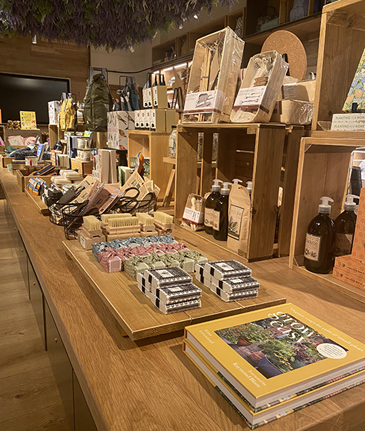 Interior of a gift shop with products neatly grouped on a long wooden table