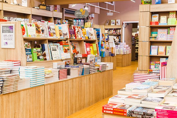 Rows of books stacked on shelving in a retail environment