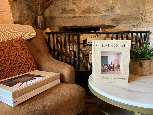 Coffee table books displayed in a rustic lounge setting