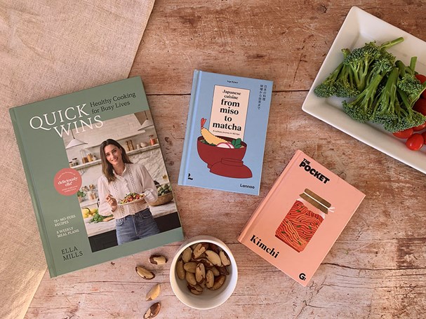 Pastel coloured food books scattered on a table.
