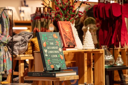 Books featuring in a retail display surrounded by scarves and candles